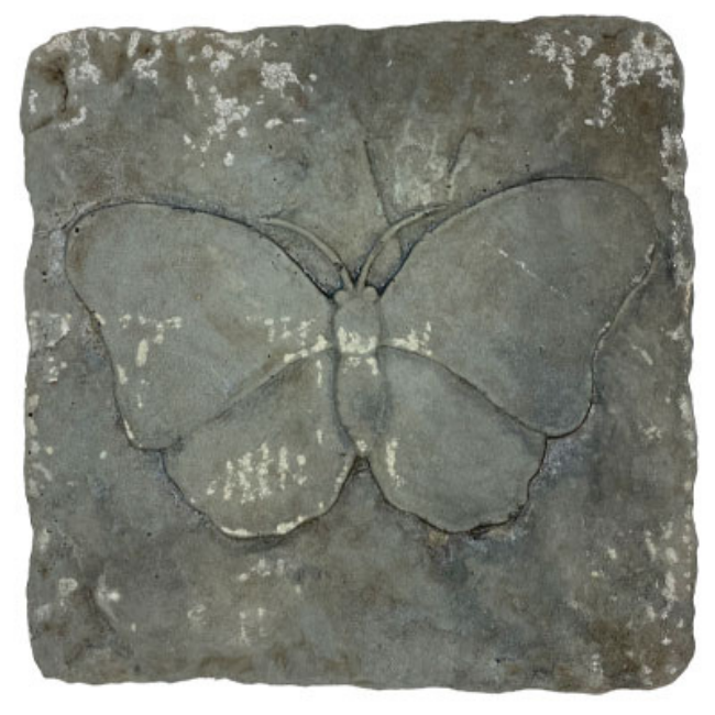Two square garden stepping stones with detailed butterfly designs, positioned on a lawn with a lush garden background.